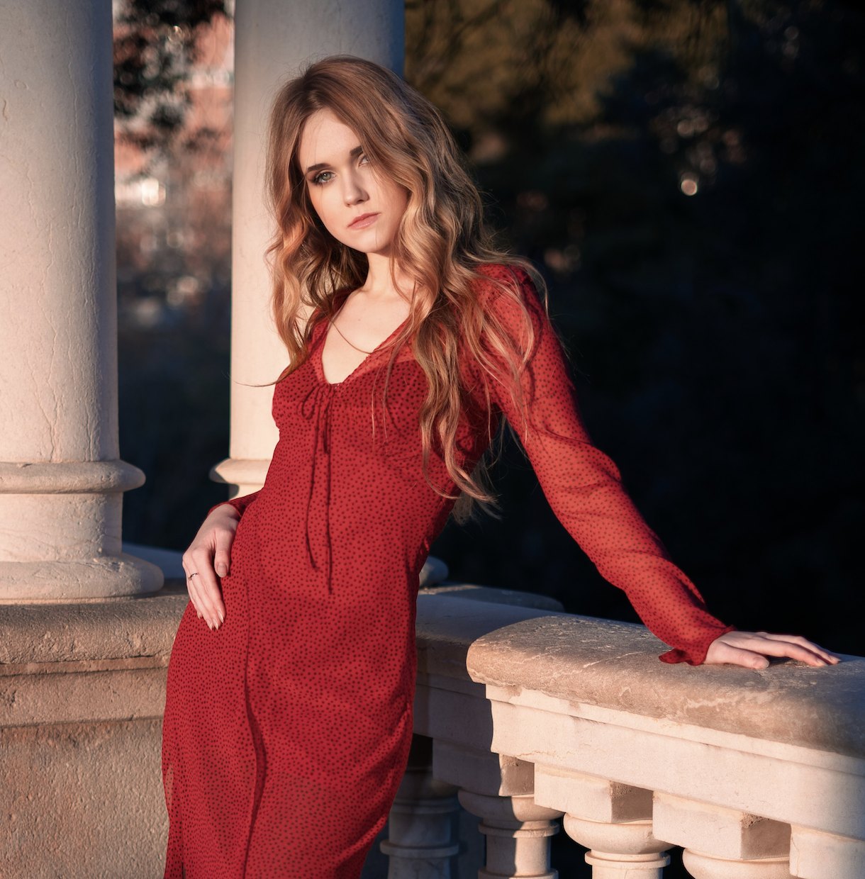 Corey June in a red dress at dusk, Barcelona